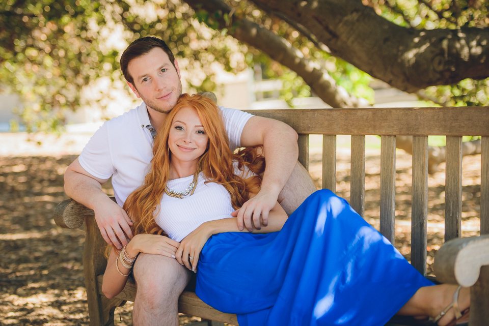 Engaged couple lounging on a park bench, Arcadia Arboretum Engagement