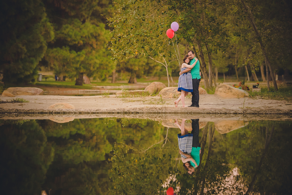 engaged couple at the lakeside, holding ballons