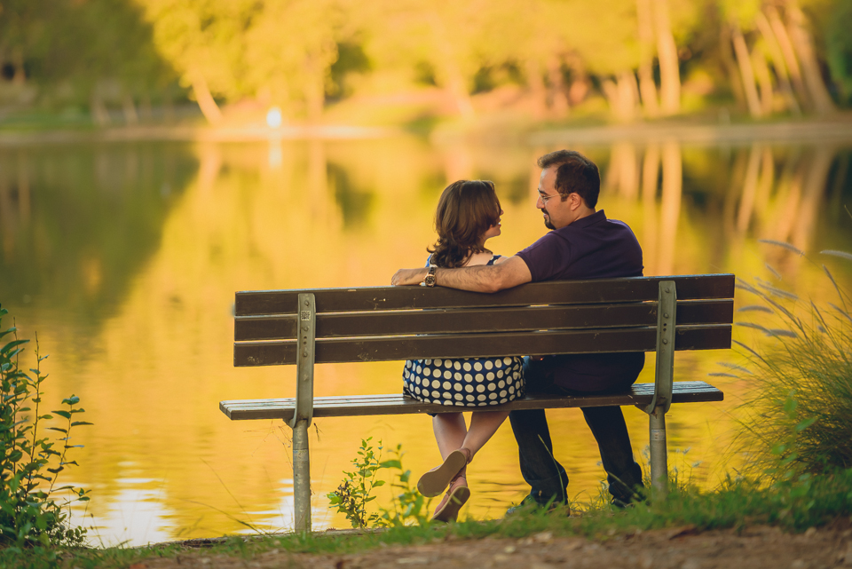 loving couple siting on the bench at the lake side