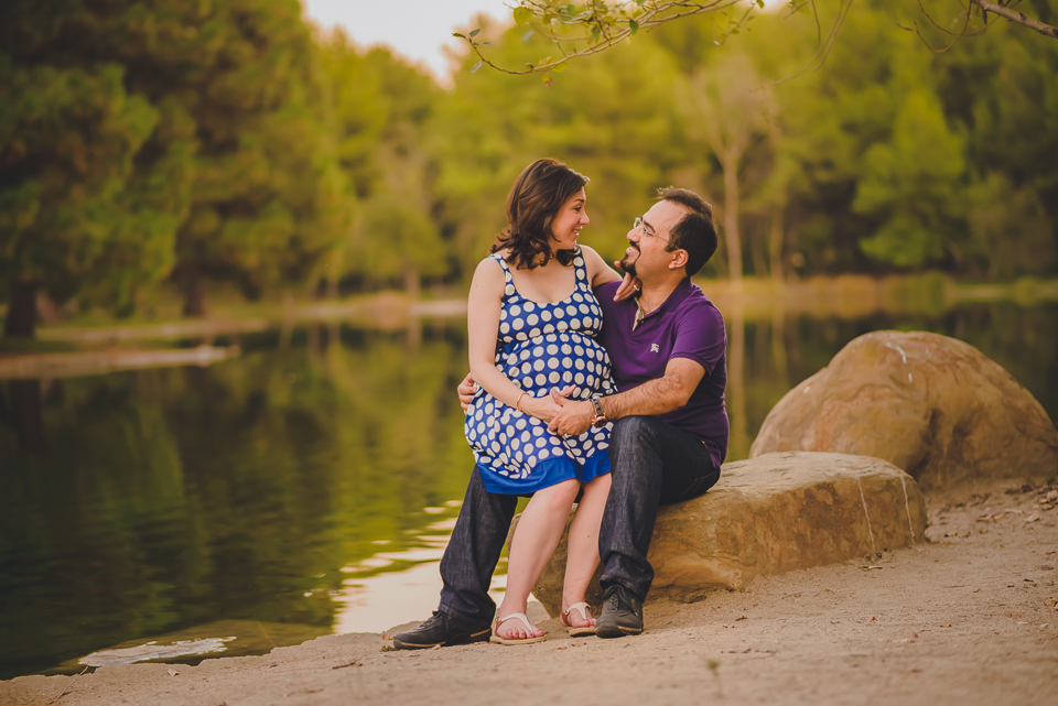 young couple sitting together at the lakeside 