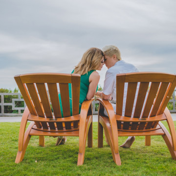 loving couple, touching their foreheads, intimate moment, sitting on Adirondack chairs